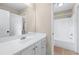 Bathroom featuring a single sink vanity with a mirror and shower/tub combo at 3413 Talking Creek Ct, Conyers, GA 30094