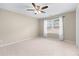 Spacious bedroom with neutral carpet, ceiling fan, and large window at 3413 Talking Creek Ct, Conyers, GA 30094