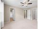 Bright bedroom showcasing a neutral carpet, ceiling fan and multiple closets at 3413 Talking Creek Ct, Conyers, GA 30094
