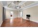 Spacious bedroom with tray ceilings, a ceiling fan, and hardwood floors at 3413 Talking Creek Ct, Conyers, GA 30094