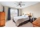 Comfortable bedroom with a ceiling fan, window with blinds, and bedside table at 3413 Talking Creek Ct, Conyers, GA 30094