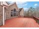 View of the home from the deck highlighting the brick exterior, arched windows, and backyard at 3413 Talking Creek Ct, Conyers, GA 30094