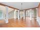 Elegant dining room with hardwood floors, decorative columns, wainscoting, and a modern chandelier at 3413 Talking Creek Ct, Conyers, GA 30094