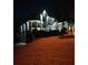 Beautiful two-story home with elegant exterior lighting, landscaping, and manicured lawn at 3413 Talking Creek Ct, Conyers, GA 30094