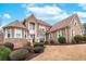 Gorgeous brick home highlighting meticulous landscaping, a circular driveway, and elegant architectural details at 3413 Talking Creek Ct, Conyers, GA 30094