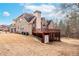 Exterior view of the brick home showcasing a deck, patio, and well-maintained yard at 3413 Talking Creek Ct, Conyers, GA 30094