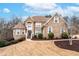 Stunning brick home featuring manicured landscaping, a circular driveway, and a welcoming entrance at 3413 Talking Creek Ct, Conyers, GA 30094