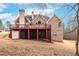 Back of home showing deck and covered patio area with access to a large backyard at 3413 Talking Creek Ct, Conyers, GA 30094