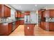 Spacious kitchen features stainless appliances, dark wood cabinetry, and an island with granite countertops at 3413 Talking Creek Ct, Conyers, GA 30094