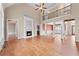 Spacious living room featuring a fireplace, hardwood floors, decorative columns, and a view of the upper level at 3413 Talking Creek Ct, Conyers, GA 30094