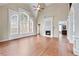 Bright living room with large windows, hardwood floors, a fireplace, and high ceilings at 3413 Talking Creek Ct, Conyers, GA 30094