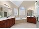 Bright bathroom boasts dual sinks, a soaking tub, and a glass-enclosed shower at 3413 Talking Creek Ct, Conyers, GA 30094