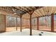 Covered patio featuring ceiling fans, brick accents, exposed wood beams, and a view of the wooded backyard at 3413 Talking Creek Ct, Conyers, GA 30094
