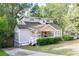 Charming house with gray siding, a white porch, and a well-maintained lawn at 1390 Almont Sw Dr, Atlanta, GA 30310