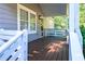 Inviting front porch with a wooden deck and white railing at 1390 Almont Sw Dr, Atlanta, GA 30310