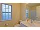 Clean bathroom with shower/tub combo, vanity with sink, and window for natural light at 2024 Appaloosa Way, Conyers, GA 30012