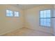 Bright bedroom with neutral walls and carpet, featuring two windows and a small shelf at 2024 Appaloosa Way, Conyers, GA 30012