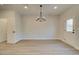 Open dining room area with hardwood floors, modern chandelier, and white trim at 4521 Twinberry Dr, Powder Springs, GA 30127