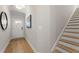 Bright entryway with light hardwood floors, white door, and staircase at 4521 Twinberry Dr, Powder Springs, GA 30127