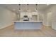 Modern kitchen with a large island, white cabinets, and pendant lighting at 4521 Twinberry Dr, Powder Springs, GA 30127