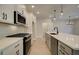 Modern kitchen with stainless steel appliances and gray cabinets at 4521 Twinberry Dr, Powder Springs, GA 30127