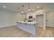 Bright kitchen features a large island, modern appliances, pendant lighting, and sleek white cabinetry at 4521 Twinberry Dr, Powder Springs, GA 30127