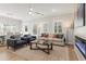 Bright living room featuring a beige sofa, fireplace and hardwood floors at 4521 Twinberry Dr, Powder Springs, GA 30127