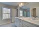 Bathroom with double vanity, large mirror, and tile floor at 4529 Twinberry Dr, Powder Springs, GA 30127