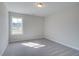 Cozy bedroom featuring soft carpeting, neutral walls, and a window with a view of the outdoors at 4529 Twinberry Dr, Powder Springs, GA 30127