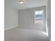 Bedroom featuring a large window and neutral carpet at 4529 Twinberry Dr, Powder Springs, GA 30127