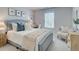 Bright bedroom with a queen-size bed, desk, and window at 4529 Twinberry Dr, Powder Springs, GA 30127