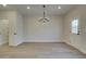 Dining room with modern chandelier lighting, wood floors, and a glass paneled door at 4529 Twinberry Dr, Powder Springs, GA 30127