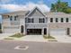 Two-story townhouses with gray siding, attached garages, and landscaping at 4529 Twinberry Dr, Powder Springs, GA 30127