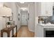 Hallway with a light wood floor that views the kitchen and front door of the house at 4529 Twinberry Dr, Powder Springs, GA 30127