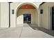 A covered arched entryway with a black double door and overhead lighting, surrounded by white brick at 120 Thome Dr, Alpharetta, GA 30022