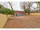 Fenced backyard showing an outside view of the home with mature trees and a level lot at 2216 Golden Dawn Sw Dr, Atlanta, GA 30311