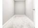 Basement area with a blank wall space, tile floors and a white entry door at 2216 Golden Dawn Sw Dr, Atlanta, GA 30311