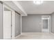 Spacious basement featuring neutral gray walls, tile floors, and white doors for room access at 2216 Golden Dawn Sw Dr, Atlanta, GA 30311