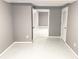 Clean basement showing painted concrete floors and multiple access doors at 2216 Golden Dawn Sw Dr, Atlanta, GA 30311