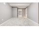 Basement space with neutral gray walls, tile floors and multiple access doors at 2216 Golden Dawn Sw Dr, Atlanta, GA 30311