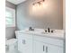 Elegant bathroom with double sink, granite countertop, modern lighting, and grey walls at 2216 Golden Dawn Sw Dr, Atlanta, GA 30311