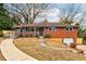 Charming red brick home with a covered porch, ramp and driveway at 2216 Golden Dawn Sw Dr, Atlanta, GA 30311