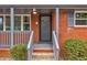 Close up of the front door and porch of a charming brick home at 2216 Golden Dawn Sw Dr, Atlanta, GA 30311