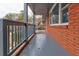 Covered porch with gray railings along the side of a brick home at 2216 Golden Dawn Sw Dr, Atlanta, GA 30311