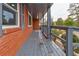 Covered porch with gray railings along the side of a brick home at 2216 Golden Dawn Sw Dr, Atlanta, GA 30311