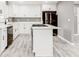 Updated kitchen with white cabinets, quartz countertops, stainless steel appliances, and a central island at 2216 Golden Dawn Sw Dr, Atlanta, GA 30311