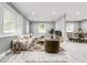 Bright staged living room and dining area with neutral walls, recessed lighting, and large windows at 2216 Golden Dawn Sw Dr, Atlanta, GA 30311