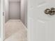 Basement storage room with white walls, tiled floor, and a white door at 2216 Golden Dawn Sw Dr, Atlanta, GA 30311