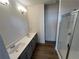 Well-lit bathroom with double vanity, modern fixtures, wood flooring, and a glass-enclosed shower at 508 Zeal Se St # 292, Atlanta, GA 30315