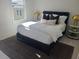 Well-lit bedroom featuring a black bed frame with neutral bedding, gold lamps, and a patterned area rug at 508 Zeal Se St # 292, Atlanta, GA 30315